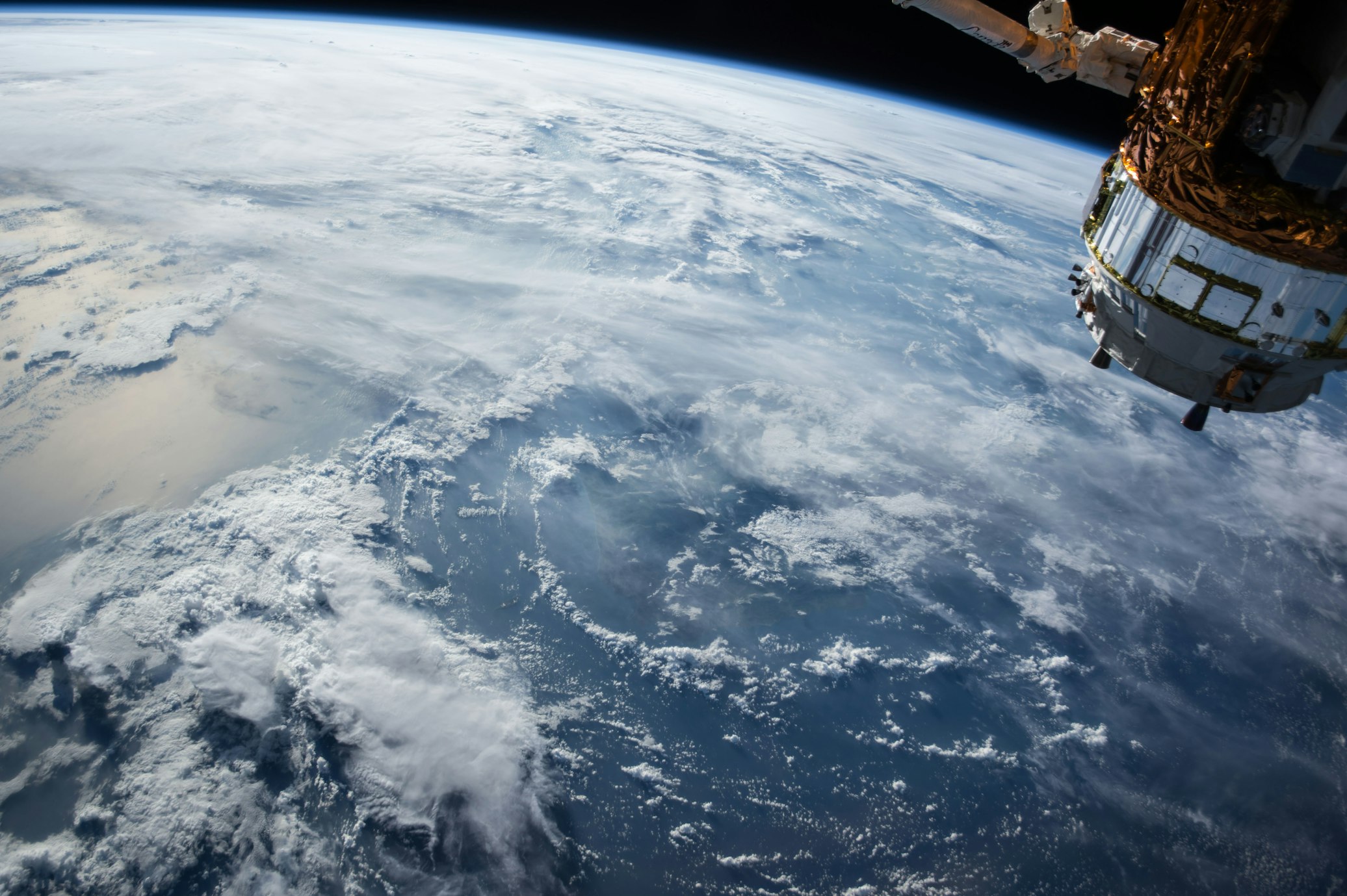 The illuminated curve of Earth against the darkness of space